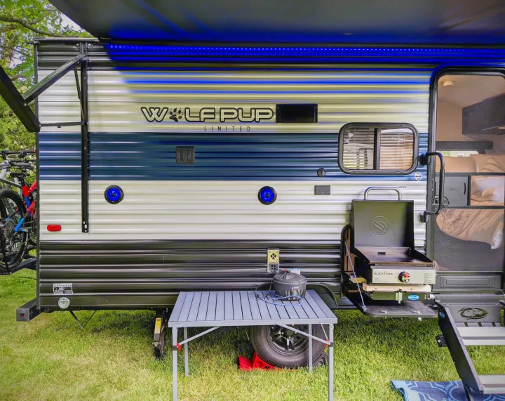 RV rental: Wolf Pup travel trailer setup for camping. Features a Blackstone griddle, table, and bikes for outdoor fun.. Forest River Cherokee Wolf Pup 2021