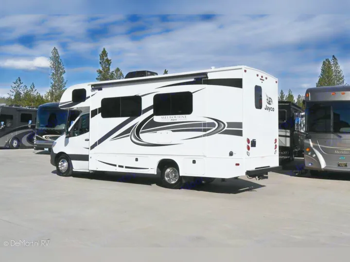 Sleek white Jayco Melbourne RV on display, ready for an rv rental. Other large motorhomes are parked alongside.. Jayco 24M 2022