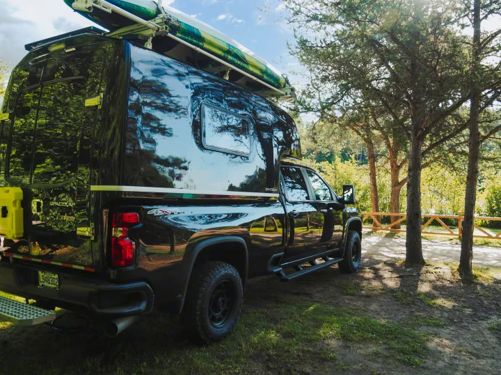 Black truck with Spacekap camper and kayak. Perfect for an adventure or RV rental, ready for scenic camping.. Chevrolet silverado 2500 2022