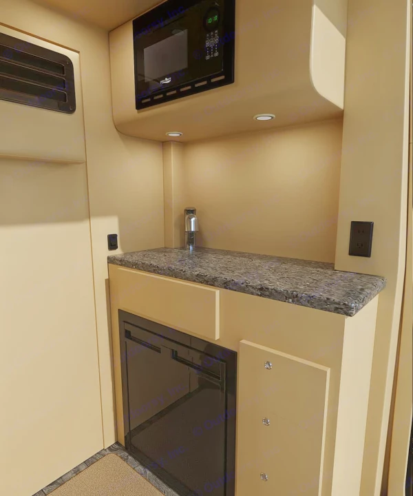 RV rental: Modern RV kitchen with microwave, sink, counter, and under-counter fridge. Perfect for compact living.. Ultimate Toys Ultimate Coach 2023
