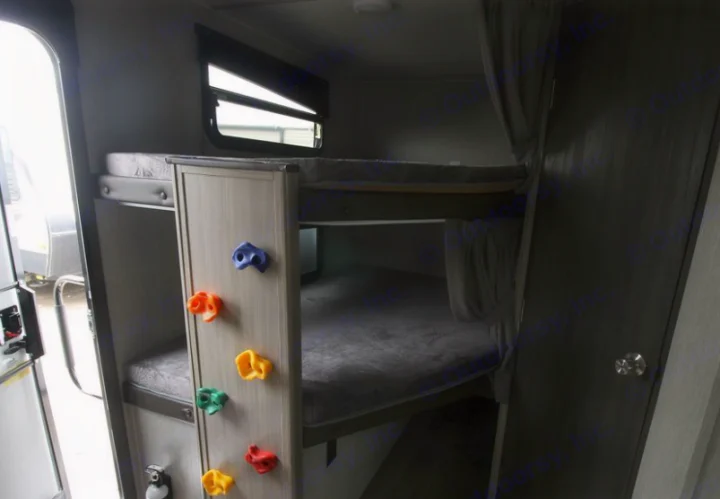 Inside this RV rental, find a kid-friendly bunk bed area with fun rock climbing holds, perfect for family adventures.. Forest River Coachmen Freedom Express Ultra Lite 2020