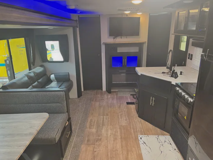 Spacious RV rental interior with living area, kitchen, and dining for comfortable travel.. Forest River Cherokee 2021