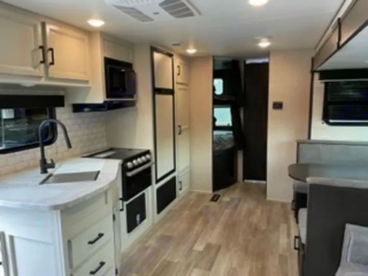 Step inside this RV rental! Bright interior with a modern kitchen, dinette, and bunk beds, perfect for family trips.. Jayco Jay Flight SLX 8 2023