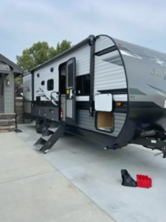 An inviting Jayco travel trailer with awning extended and steps deployed, perfect for your next RV rental or camping trip.. Jayco Jay Flight SLX 8 2023