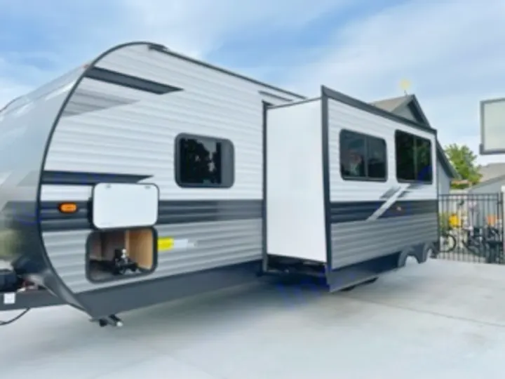 This modern gray travel trailer with an extended slide-out and open storage is ready for your next RV rental adventure.. Jayco Jay Flight SLX 8 2023