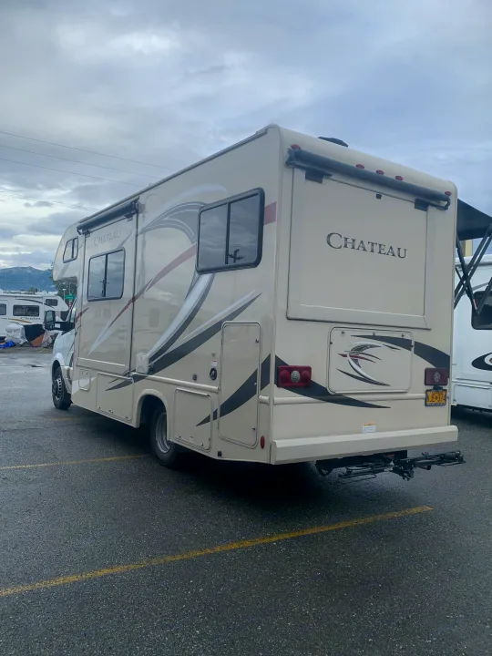 Explore with this Chateau RV rental, parked under a cloudy sky. Features a bike rack and Alaska license plate KJE 374.. Thor Motor Coach Chateau Sprinter 2018