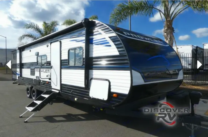 Prowler travel trailer, white/black with blue accents, steps extended. Perfect for your next rv rental adventure!. Heartland Prowler 2022