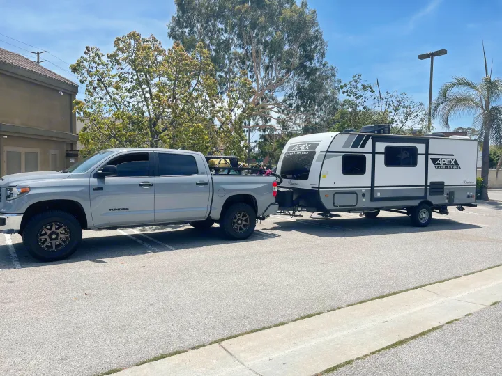 Grey Tundra truck towing an Apex Nano Off Grid travel trailer, perfect for your next RV rental adventure.. Forest River Coachman Apex Nano 2022