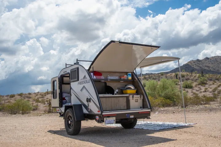 An rv rental, a FreeSolo teardrop camper, features an open rear kitchen & side awning for desert camping.. Braxton Creek Free Solo 2022