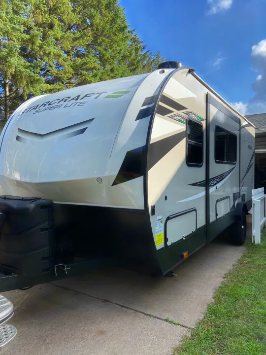 Starcraft Super Lite RV rental: A sleek travel trailer parked on a sunny driveway, ready for trips.. Starcraft Super Lite Maxx 2022