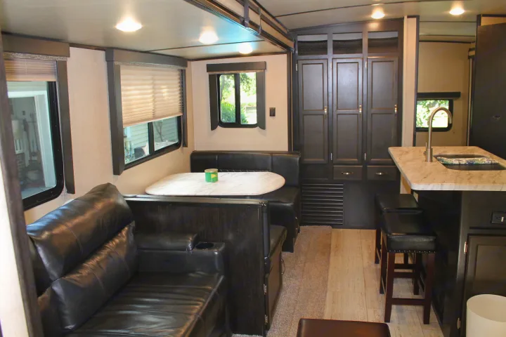 Modern RV rental interior showing a comfortable living area, dinette, and sleek kitchen island.. Coachmen Spirit Ultralight 2020