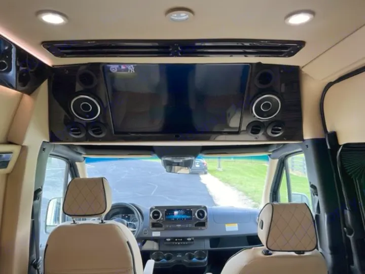 Luxury RV rental interior with TV, speakers, and plush front cabin. Ideal for comfortable road trips.. Ultimate Toys Ultimate Coach 2023