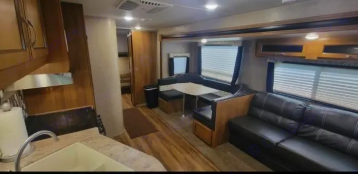Bright RV rental interior: kitchen, dinette, and sofa area. Perfect for your next travel adventure!. Coachmen Catalina 2019