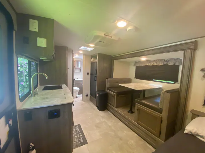 Spacious RV rental interior with kitchen, dinette, and bathroom. Perfect for comfortable and convenient travel adventures.. Coachmen Apex Nano 2021