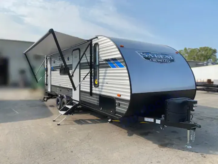 New grey Salem Cruise Lite travel trailer RV with extended awning & steps down, ideal for your next RV rental.. Forest River Salem Cruise Lite 2022