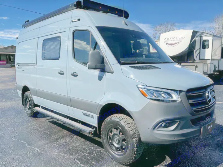 A sleek grey Winnebago Revel adventure van, perfect for your next RV rental. Equipped for off-road travel.. Winnebago Revel 2022