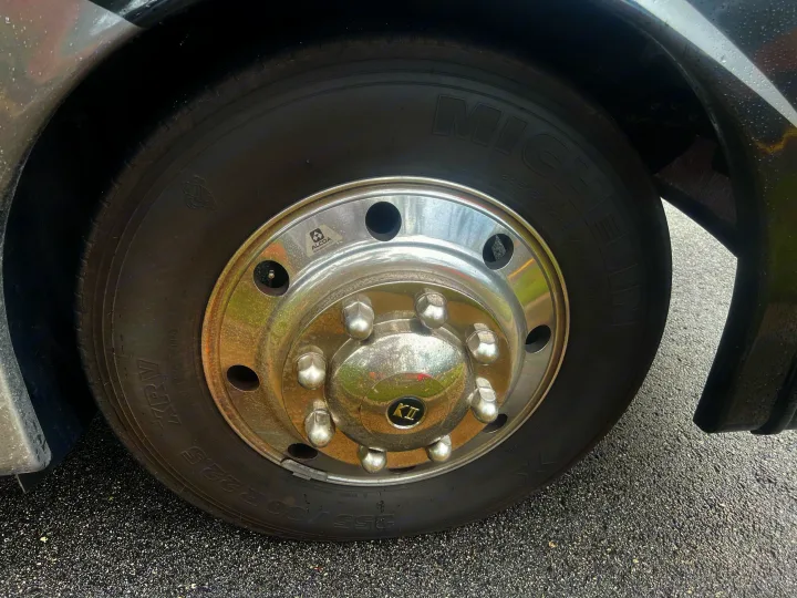 Large Michelin XRV tire and shiny Alcoa wheel on an RV rental, size 255/80R22.5. Ready for reliable adventures.. Thor Outlaw 2022