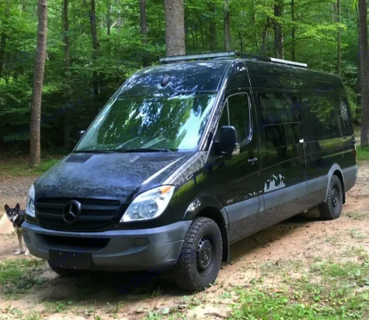 Explore the woods in this black Mercedes Sprinter camper van with off-road tires. Your next RV rental adventure awaits, even with your dog!. Mercedes Sprinter 2012