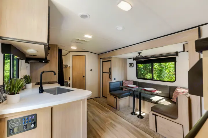 Spacious rv rental interior with kitchen, dinette, and bunk beds, perfect for family travel.. North Trail 24bhs 2021