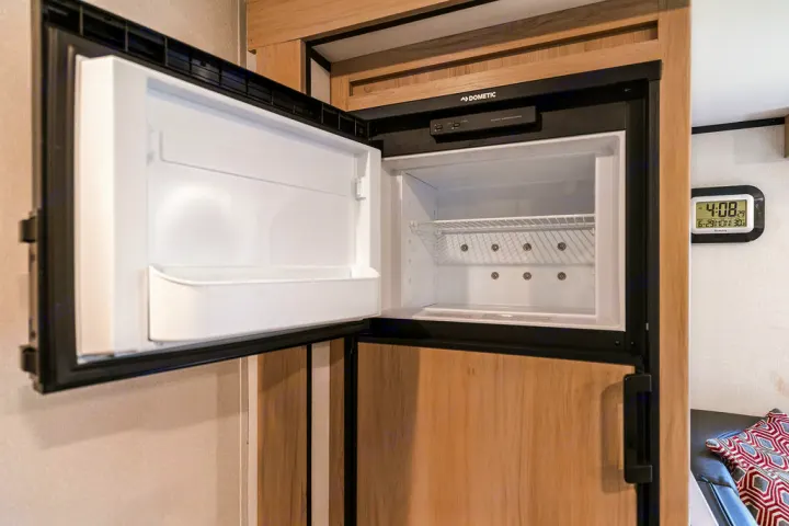 Clean, empty Dometic refrigerator & freezer inside this RV rental, ready for your provisions.. North Trail 24bhs 2021