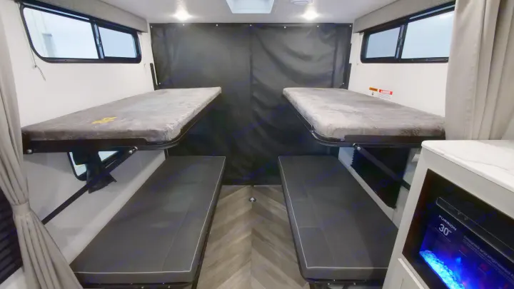RV rental: Rear bunk beds and bench seating provide versatile sleeping/cargo space in this modern interior.. Forest River Wildwood 2022