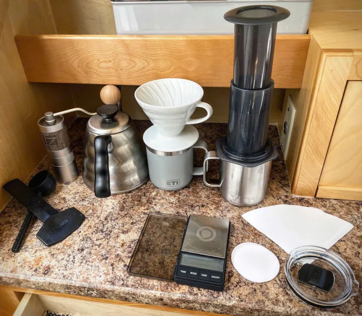 Portable coffee brewing essentials: AeroPress, pour-over, grinder & scale, neatly organized for an RV rental kitchen.. Little Guy Little Guy Trailer 2013