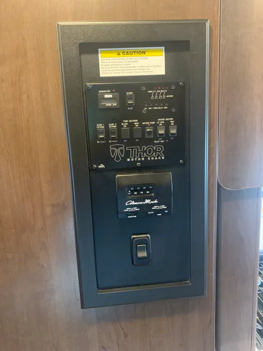 RV rental control panel: generator, slide-outs, water heater, tank levels, & Coleman-Mach thermostat for easy operation.. Thor Motor Coach Four Winds 2018