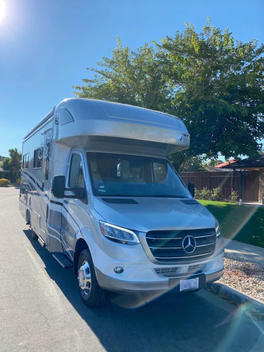 This sleek Mercedes-Benz Class C RV, available for rv rental, is parked on a bright, sunny street.. Winnebago View 2022