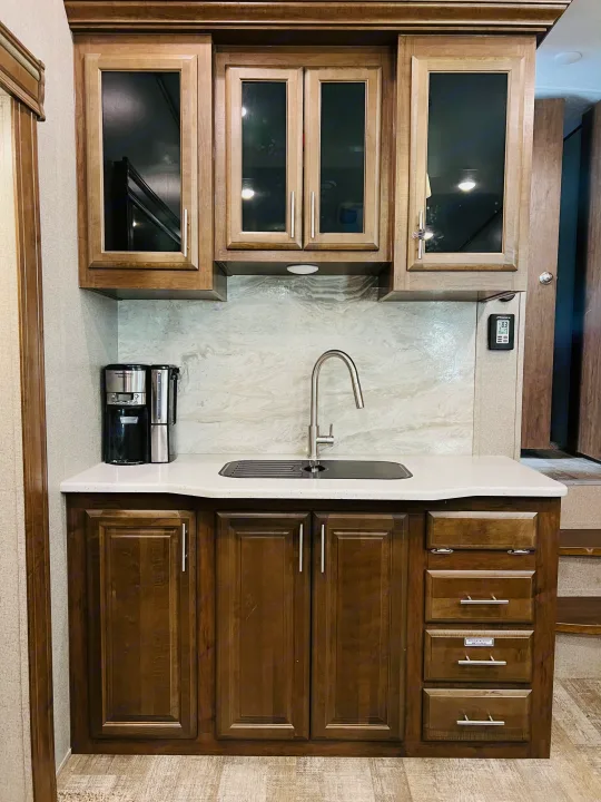 RV rental kitchen: Modern cabinetry, sleek sink, and coffee maker provide functional living space for your travels.. Forest River Rockwood Ultra Lite 2020