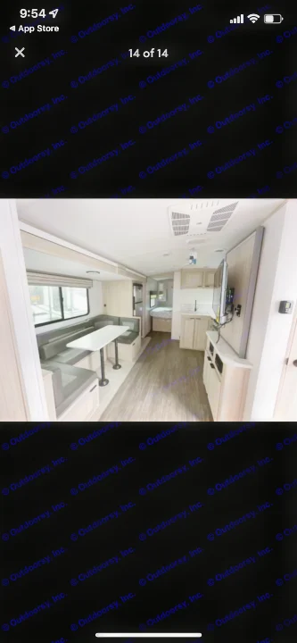 Inside a modern rv rental: U-shaped dinette, kitchen, and bedroom. Light wood accents, gray seating, and durable wood-look flooring.. Shadow Trailers 277bhs 2022