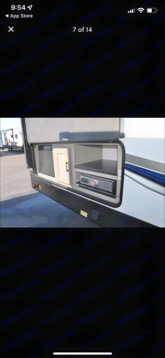 RV rental: Outdoor kitchen with mini-fridge, cabinet, and built-in grill/stove. Ideal for outdoor cooking & storage.. Shadow Trailers 277bhs 2022