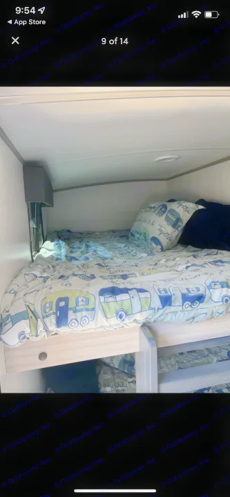 Cozy bunk beds in an RV rental, featuring fun camper-themed bedding, ideal for family travel in a recreational vehicle.. Shadow Trailers 277bhs 2022