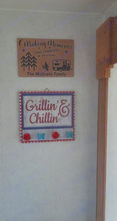 Two decorative signs on a wall: a "Making Memories" sign with an RV & campfire, and a "Grillin' & Chillin'" sign. Ideal for an rv rental.. Shasta Flite 2000