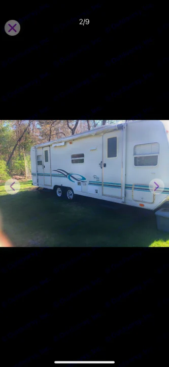 White Flite travel trailer with teal accents, great for RV rental. Parked on green grass outdoors.. Shasta Flite 2000