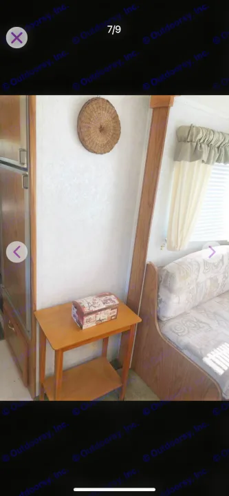 RV rental interior: dinette seating, wall decor, and small table near kitchen. Cozy, compact space for adventure.. Shasta Flite 2000
