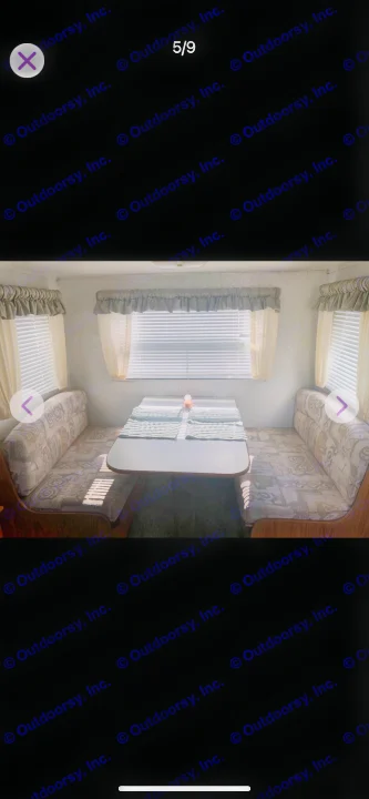 RV rental dinette area featuring a U-shaped booth with patterned cushions, a table, and multiple windows with blinds.. Shasta Flite 2000