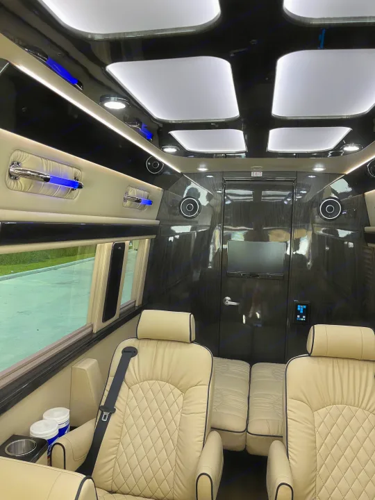 Experience a premium RV rental's lavish interior: cream quilted seats, ambient lighting, and entertainment setup.. Midwest Automotive Designs Midwest Automotive Designs Class B 2021