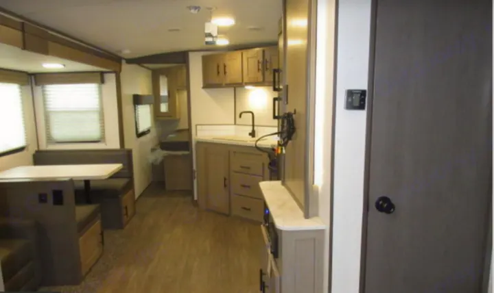 Spacious and modern RV rental interior with practical kitchen, dinette, and entertainment center. Perfect for your travels.. Cruiser RV Shadow Cruiser 2022