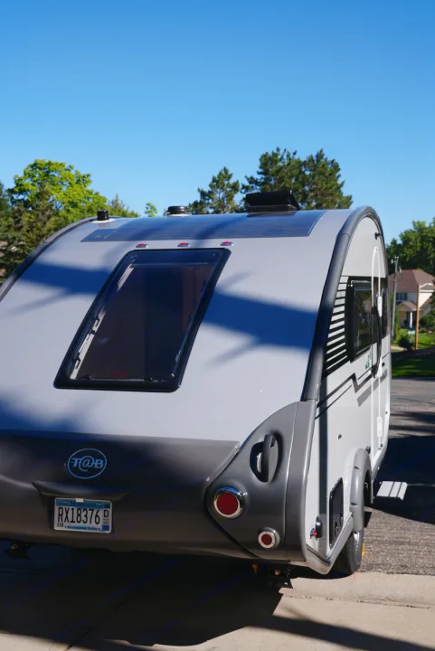 Sleek gray teardrop rv rental trailer with window & solar panel, ready for your outdoor travel adventures.. Nucamp Tab 400 2022