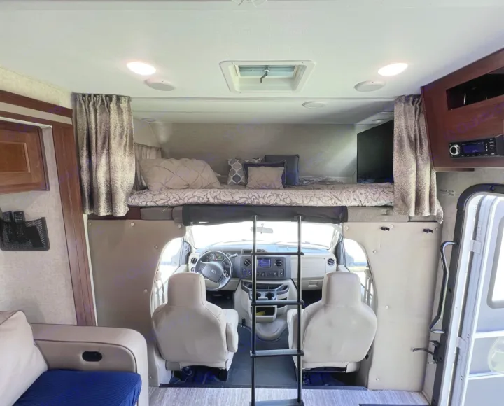 Inside an RV rental: a cozy motorhome with front cockpit, over-cab bunk, ladder, and all comforts for your next adventure.. Forester LE 2020