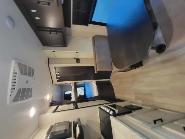 Modern RV rental interior: kitchenette, dining area, and cozy sleeping space for travel comfort.. Jayco Jay Flight SLX 2022