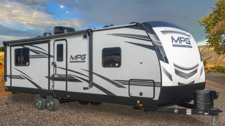 White MPG travel trailer for RV rental, parked with a mountain backdrop. Ideal for outdoor adventures.. Cruiser RV MPG Ultra Lite 2022