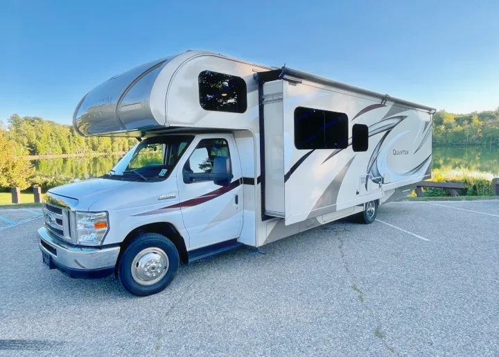 Thor Quantum Class C RV rental, with slide-out extended and awning deployed, parked lakeside. Ready for adventure!. Thor Quantum 2017