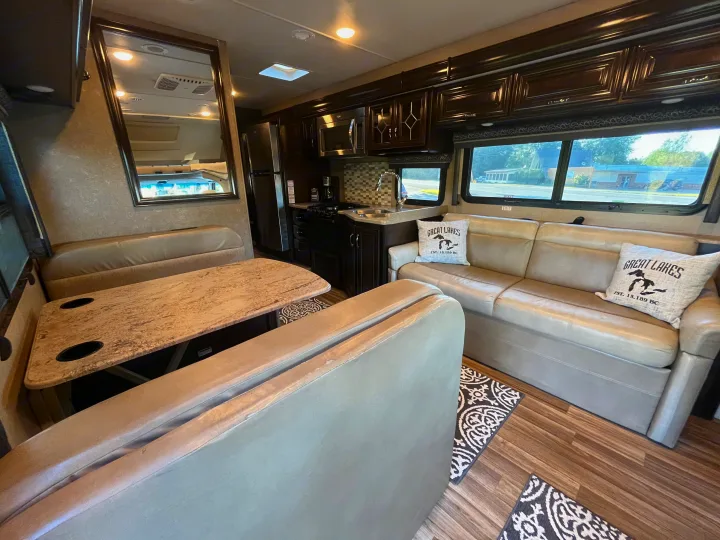Spacious RV rental interior with full kitchen, dinette, and comfortable sofa for your next adventure.. Thor Quantum 2017