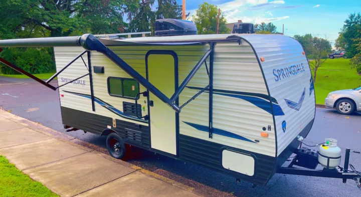 This Springdale travel trailer RV rental features an extended awning, ready for your next outdoor adventure.. Keystone RV Springdale 2022