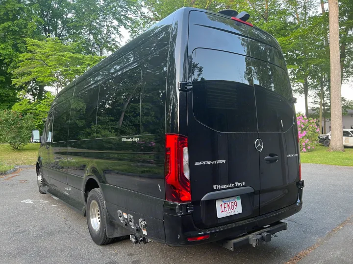This black Mercedes-Benz Sprinter luxury rv rental by Ultimate Toys, labeled "CAMPER," is parked outdoors.. Ultimate Toys Ultimate Coach 2022
