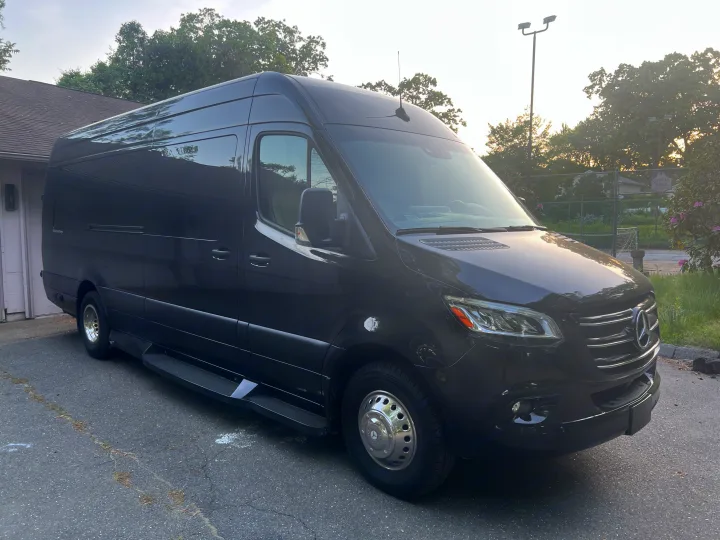 Black Mercedes-Benz Sprinter RV rental parked on asphalt, ideal for luxury travel and road trips.. Ultimate Toys Ultimate Coach 2022