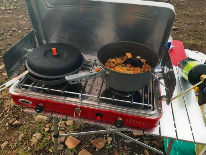 RV rental adventure! Enjoying a hot meal cooked outdoors on a portable camping stove. Perfect for road trips and nature.. Jeep Patriot 2016