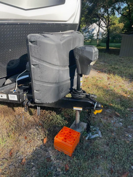 RV rental front hitch & propane area with leveling blocks. Diamond plate trailer, ideal for camping adventures.. Winnebago Voyage 2021