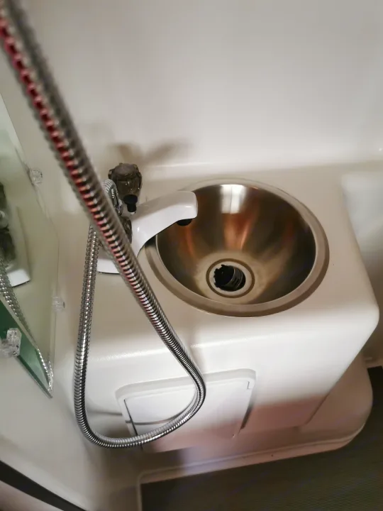 Compact rv rental sink with integrated shower hose and faucet. Ideal for small spaces.. Winnebago Travato 2018